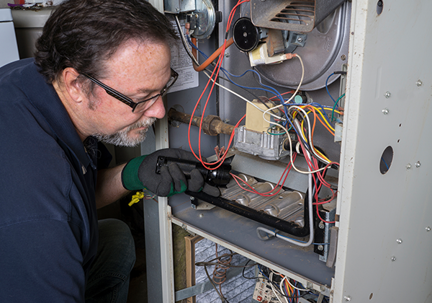 tech works on furnace