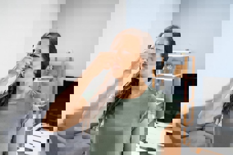 woman holding her nose